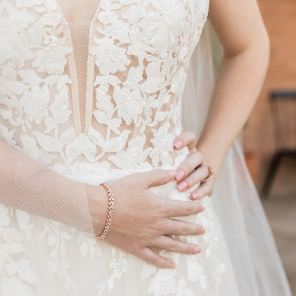 Bride feeling how wedding dress fits